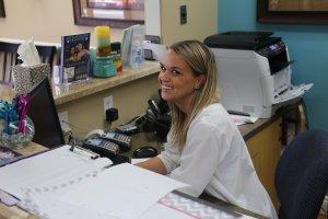 smiling staff member at front desk