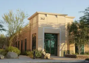 The image shows the exterior of a modern building with a clean, professional design.