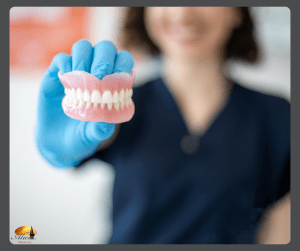 A dental professional wearing blue gloves holding a set of soft liners dentures.
